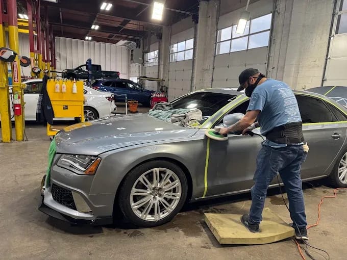 Audi RS7 grey paint correction — technician polishing with masking tape in shop Springfield OR